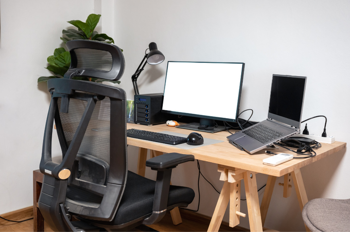 A modern desk featuring an ergonomic computer setup with a keyboard and mouse, reflecting ergonomic office furniture trends.